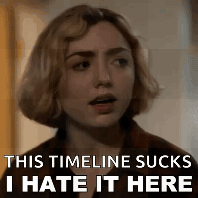 A Close Up Of A Woman 'S Face With The Words `` This Timeline Sucks I Hate It Here '' . GIF