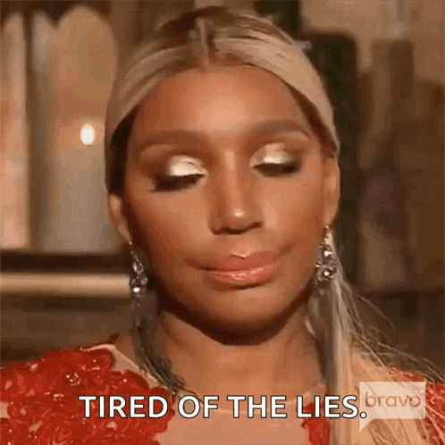 A Close Up Of A Woman 'S Face With The Words `` Tired Of The Lies '' Written On It . GIF