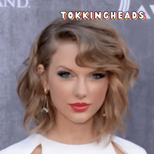 A Close Up Of A Woman 'S Face With The Words Tokingheads Below Her GIF