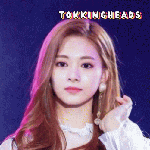 A Close Up Of A Woman 'S Face With The Words Tokingheads Written Above Her GIF