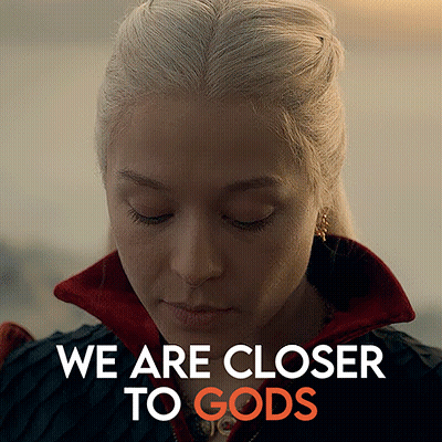 A Close Up Of A Woman 'S Face With The Words " We Are Closer To Gods " Above Her GIF