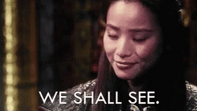 A Close Up Of A Woman 'S Face With The Words `` We Shall See '' Written On It . GIF