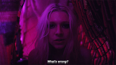 A Close Up Of A Woman 'S Face With The Words `` What 'S Wrong ? '' Written On The Bottom . GIF