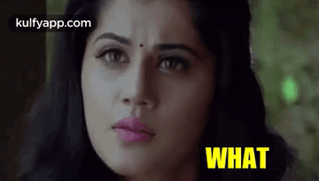 A Close Up Of A Woman 'S Face With The Words `` What '' Written In Yellow . GIF