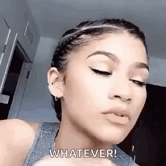 A Close Up Of A Woman 'S Face With The Words `` Whatever '' On Her Face . GIF
