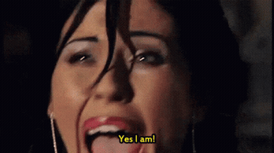 A Close Up Of A Woman 'S Face With The Words Yes I Am Behind Her GIF