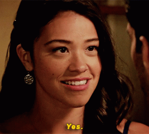 A Close Up Of A Woman 'S Face With The Words " Yes " On The Bottom GIF