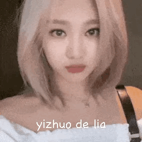 A Close Up Of A Woman 'S Face With The Words Yizhuo De Lia Written On It . GIF