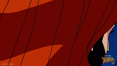 A Close Up Of A Woman 'S Face With The X-Men Logo On The Bottom Right GIF