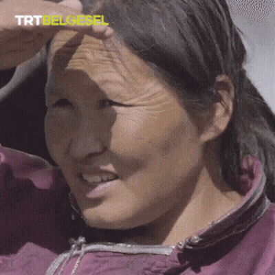 A Close Up Of A Woman 'S Face With Trtbelgesel Written In Yellow GIF