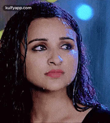 A Close Up Of A Woman 'S Face With Water Coming Out Of Her Hair . GIF