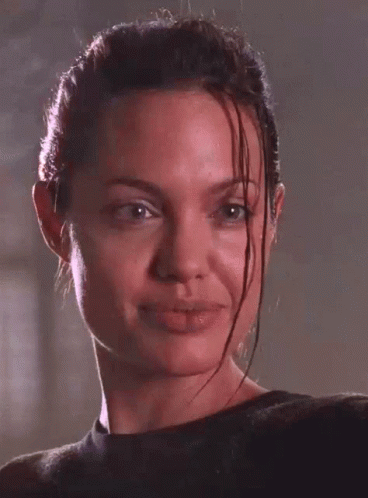A Close Up Of A Woman 'S Face With Wet Hair Making A Funny Face GIF