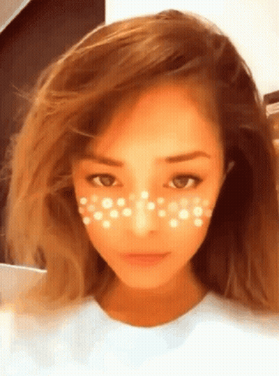 A Close Up Of A Woman 'S Face With White Dots On Her Face GIF