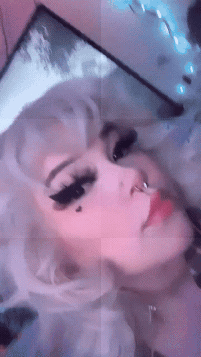 A Close Up Of A Woman 'S Face With White Hair And A Nose Ring GIF