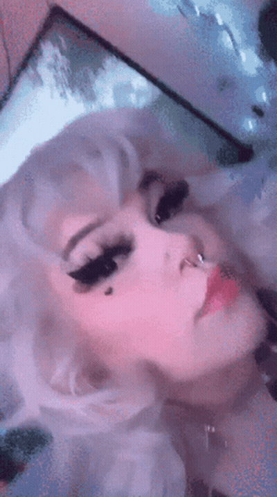 A Close Up Of A Woman 'S Face With White Hair And A Nose Ring GIF