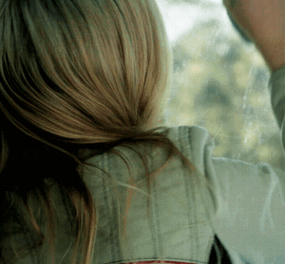 A Close Up Of A Woman 'S Hair And A Man 'S Face GIF