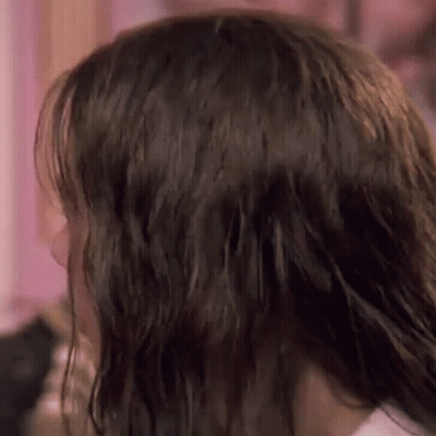 A Close Up Of A Woman 'S Hair In A Room . GIF