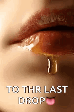 A Close Up Of A Woman 'S Lips With A Drop Of Honey Dripping Out Of Them . GIF