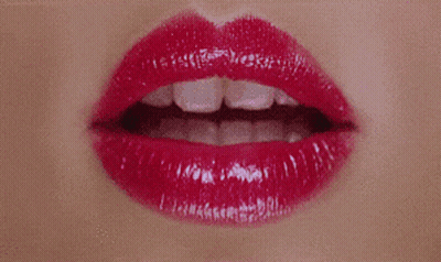 A Close Up Of A Woman 'S Lips With Red Lipstick And White Teeth GIF