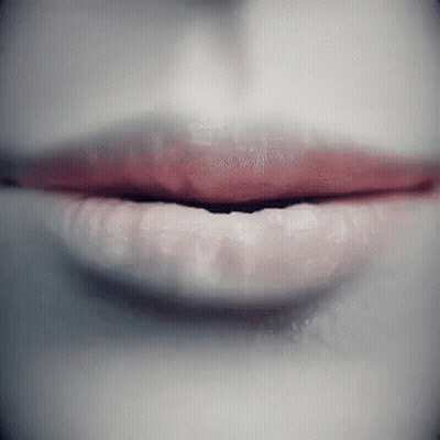 A Close Up Of A Woman 'S Lips With Red Lipstick On GIF