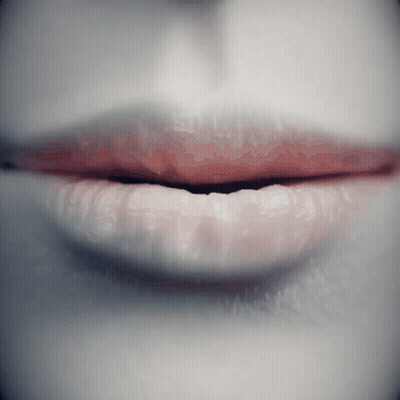 A Close Up Of A Woman 'S Lips With Red Lipstick On Them GIF