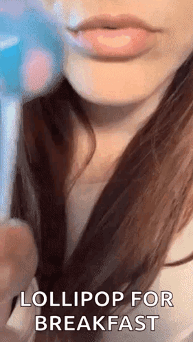 A Close Up Of A Woman 'S Lips With The Words Lollipop For Breakfast . GIF