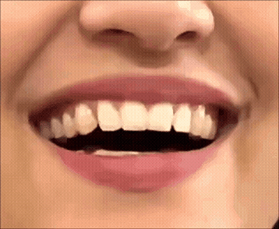 A Close Up Of A Woman 'S Mouth With Her Teeth Visible . GIF