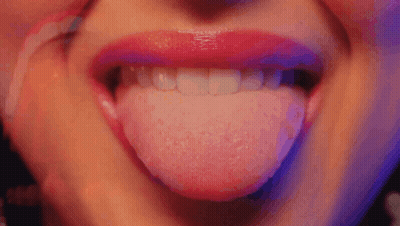 A Close Up Of A Woman 'S Mouth With Her Tongue Out GIF