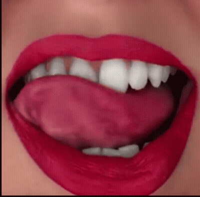 A Close Up Of A Woman 'S Mouth With Her Tongue Out GIF