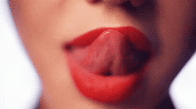 A Close Up Of A Woman 'S Mouth With Her Tongue Sticking Out . GIF