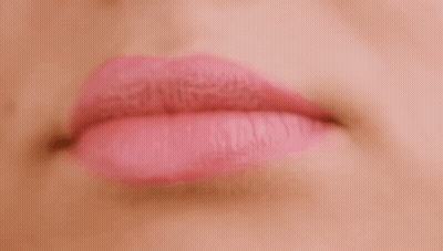 A Close Up Of A Woman 'S Mouth With Pink Lipstick . GIF