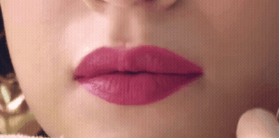A Close Up Of A Woman 'S Mouth With Pink Lipstick . GIF