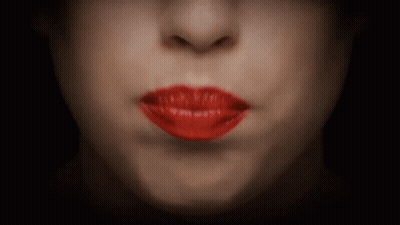 A Close Up Of A Woman 'S Mouth With Red Lips GIF