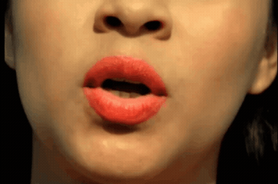 A Close Up Of A Woman 'S Mouth With Red Lipstick On GIF