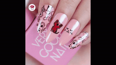 A Close Up Of A Woman 'S Nails With A Cat Design GIF