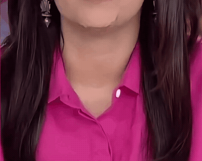 A Close Up Of A Woman 'S Neck And Neckline In A Pink Shirt GIF