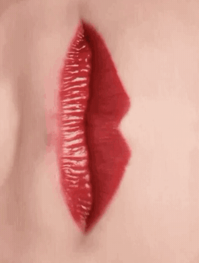 A Close Up Of A Woman 'S Red Lips With Red Lipstick . GIF