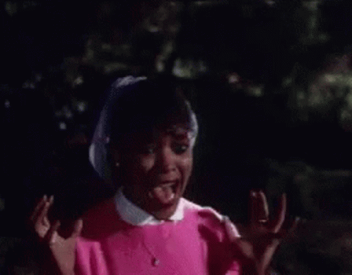 A Close Up Of A Woman Screaming With Her Mouth Open GIF