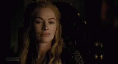 A Close Up Of A Woman Sitting In A Chair In The Dark . GIF