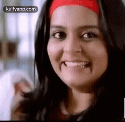 A Close Up Of A Woman Smiling With A Red Headband On Her Head . GIF