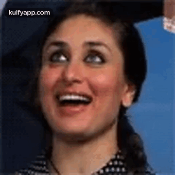 A Close Up Of A Woman Smiling With Her Mouth Open . GIF