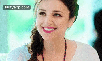 A Close Up Of A Woman Smiling With Pink Lipstick And A Braid . GIF