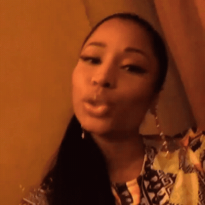 A Close Up Of A Woman Smoking A Cigarette While Taking A Selfie . GIF