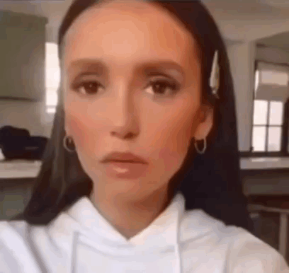 A Close Up Of A Woman Taking A Selfie In A Kitchen . GIF