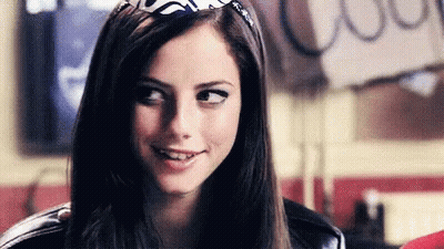 A Close Up Of A Woman Wearing A Bandana On Her Head And Smiling . GIF