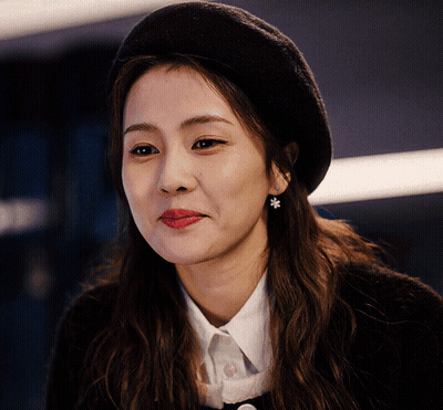 A Close Up Of A Woman Wearing A Black Beret GIF