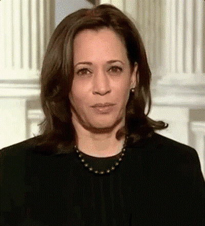 A Close Up Of A Woman Wearing A Black Shirt And A Necklace . GIF
