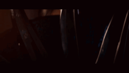A Close Up Of A Woman Wearing A Blue And Gold Mask GIF