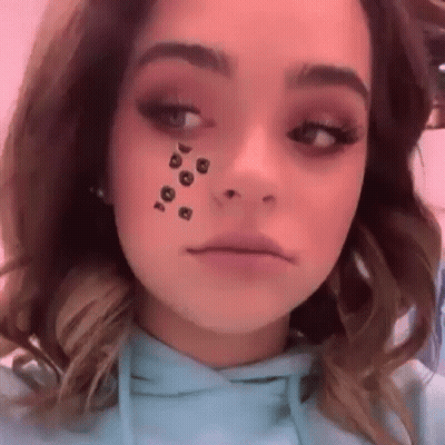 A Close Up Of A Woman Wearing A Blue Hoodie With A Leopard Print On Her Face . GIF
