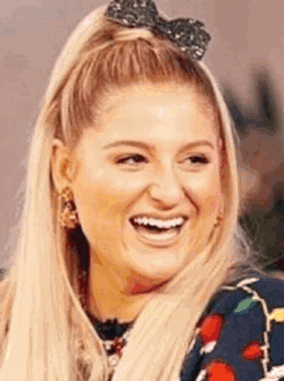 A Close Up Of A Woman Wearing A Bow In Her Hair . GIF